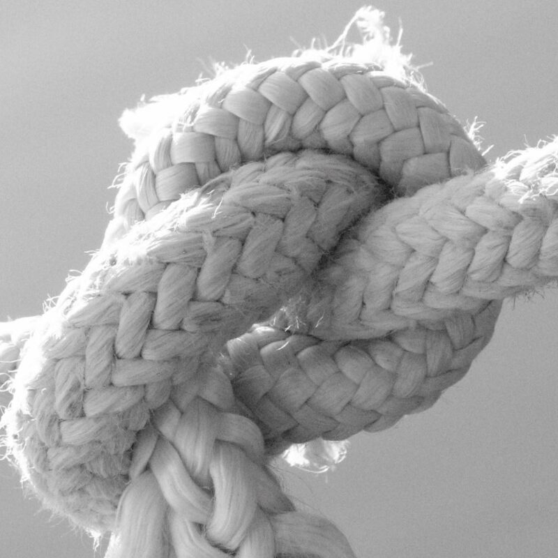 A Grayscale Photo of a Tied Rope