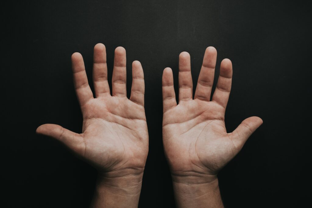 two hands with black background