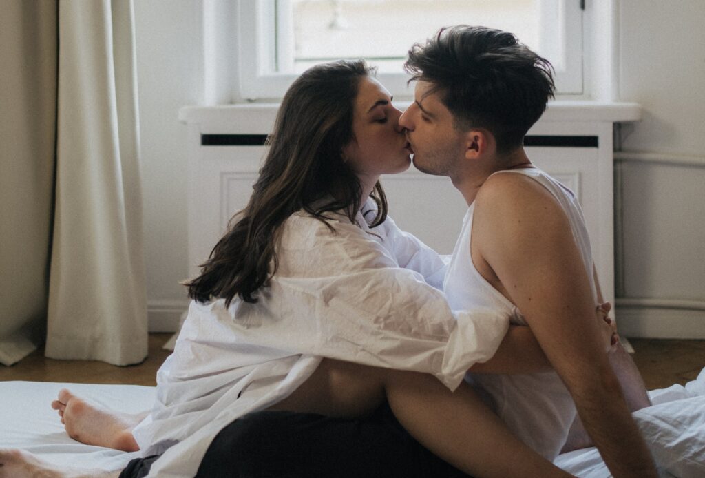 Man and Woman Sitting While Kissing 