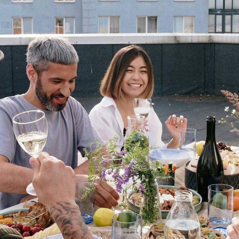 Swinger couples sitting at dinner table