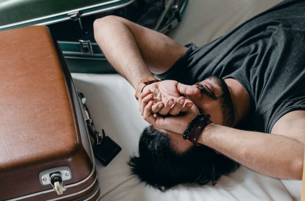 Anxious man lying on bed