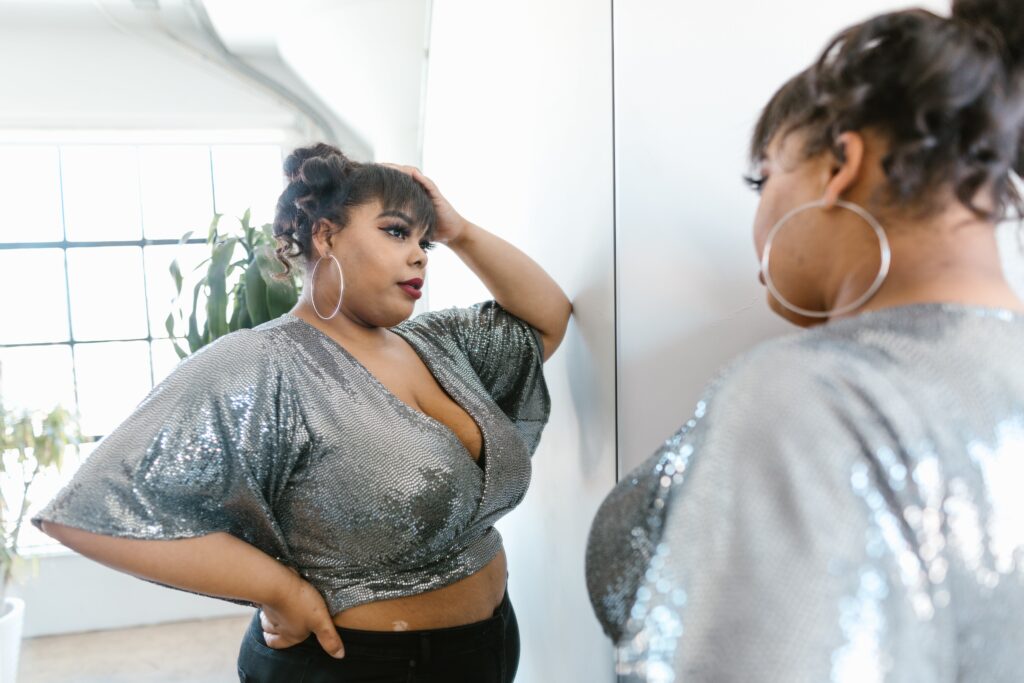 Woman Wearing Crop Top Looking at a Mirror