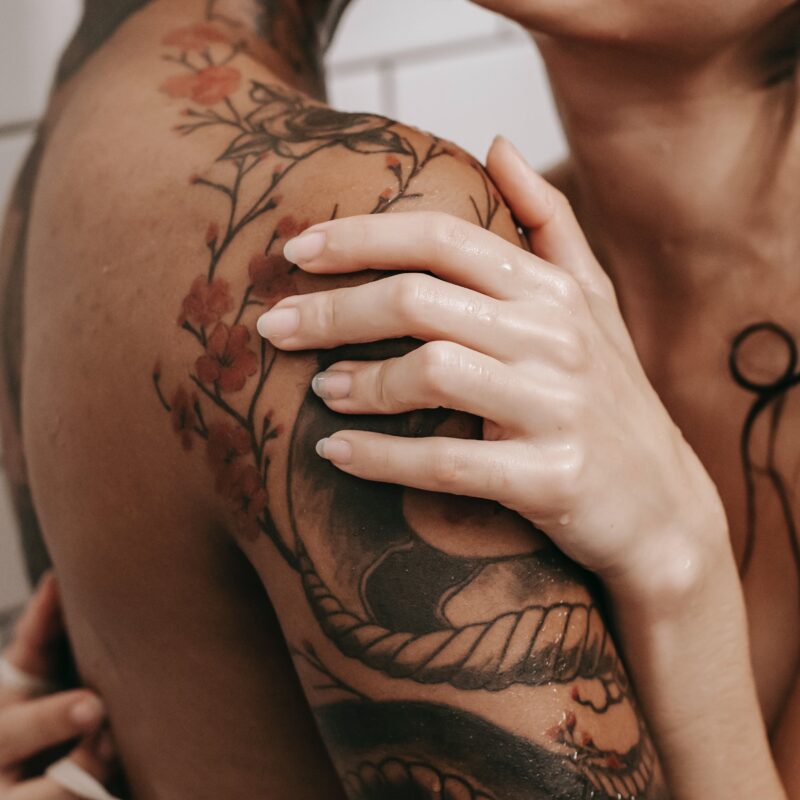 Erotic diverse couple embracing in shower