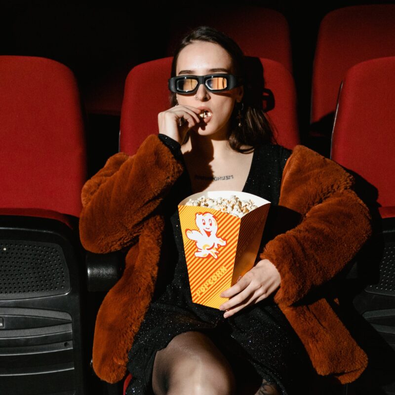 A Woman Watching a Movie About Swingers Eating Popcorn