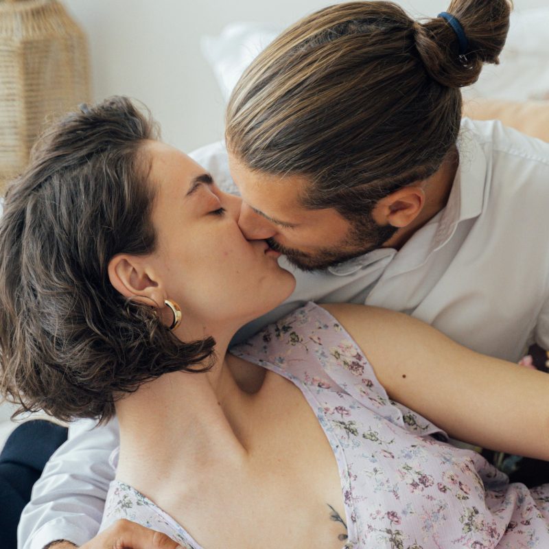 Open-minded swinger couple kissing