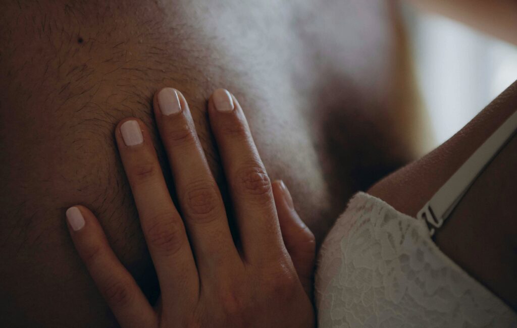 Woman and man embracing at a swinger party