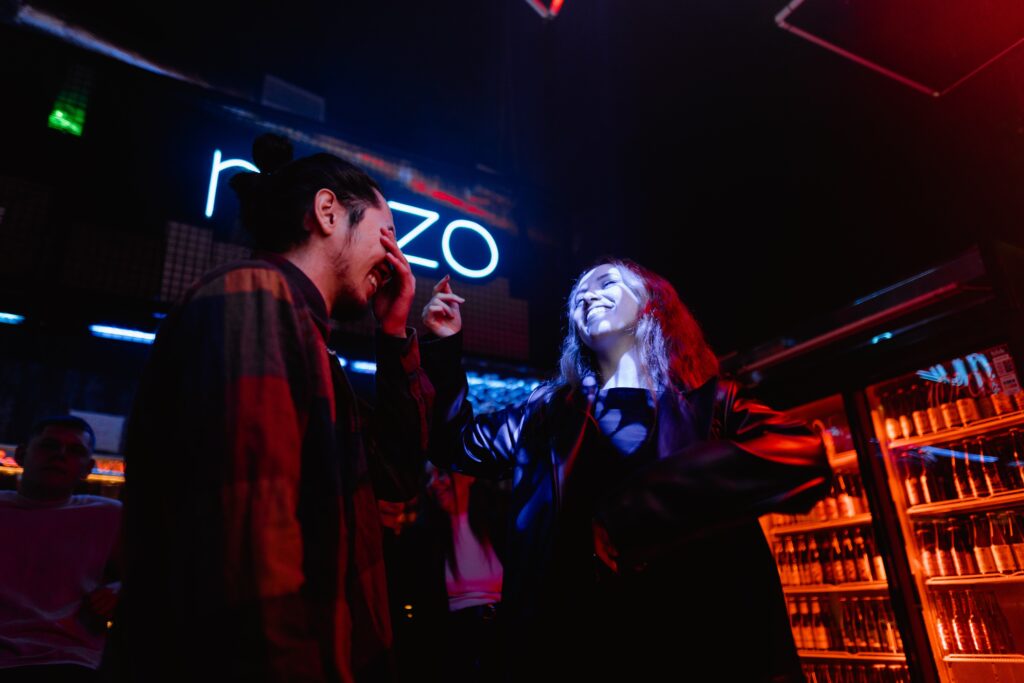 A man and a woman joking at a swinger club