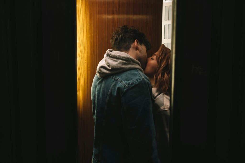 Couple kissing in dark corner