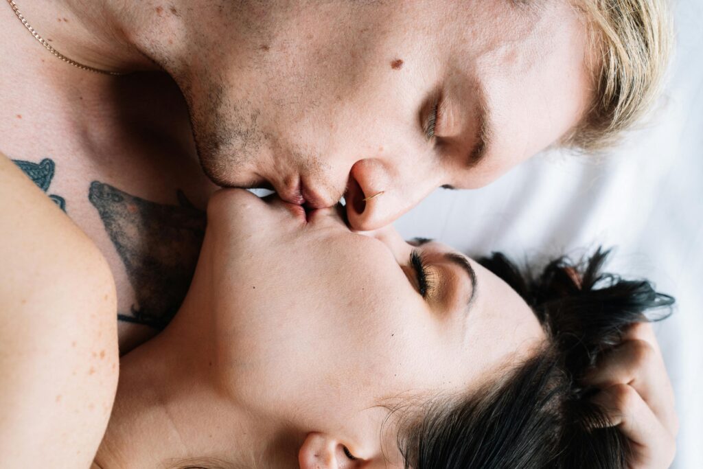 Erotic Couple Kissing while Lying Down
