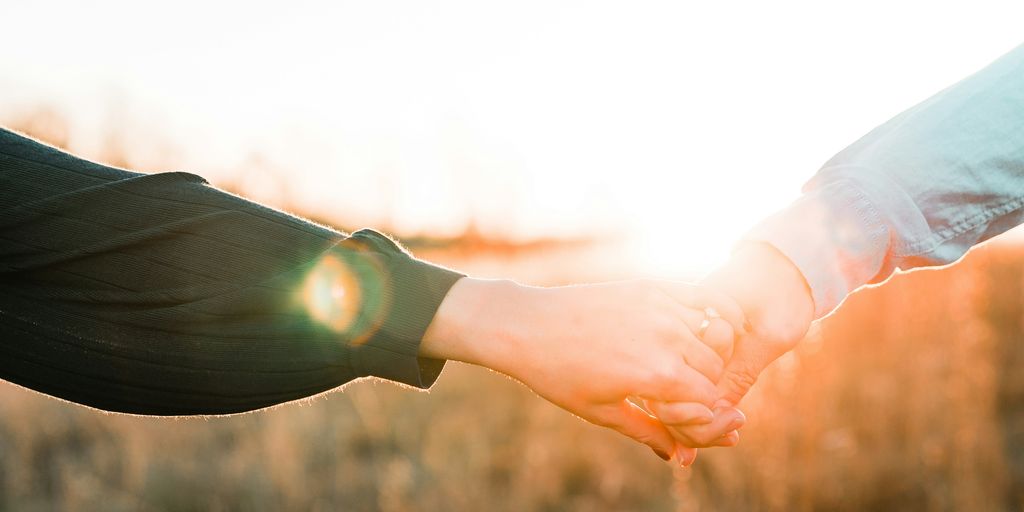 two person holding each other's hands