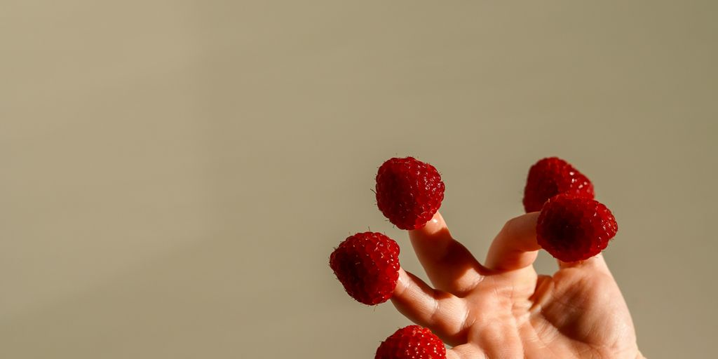 berries in fingers