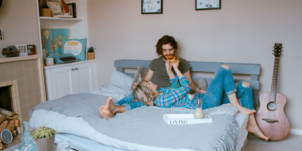 man and woman lying on bed