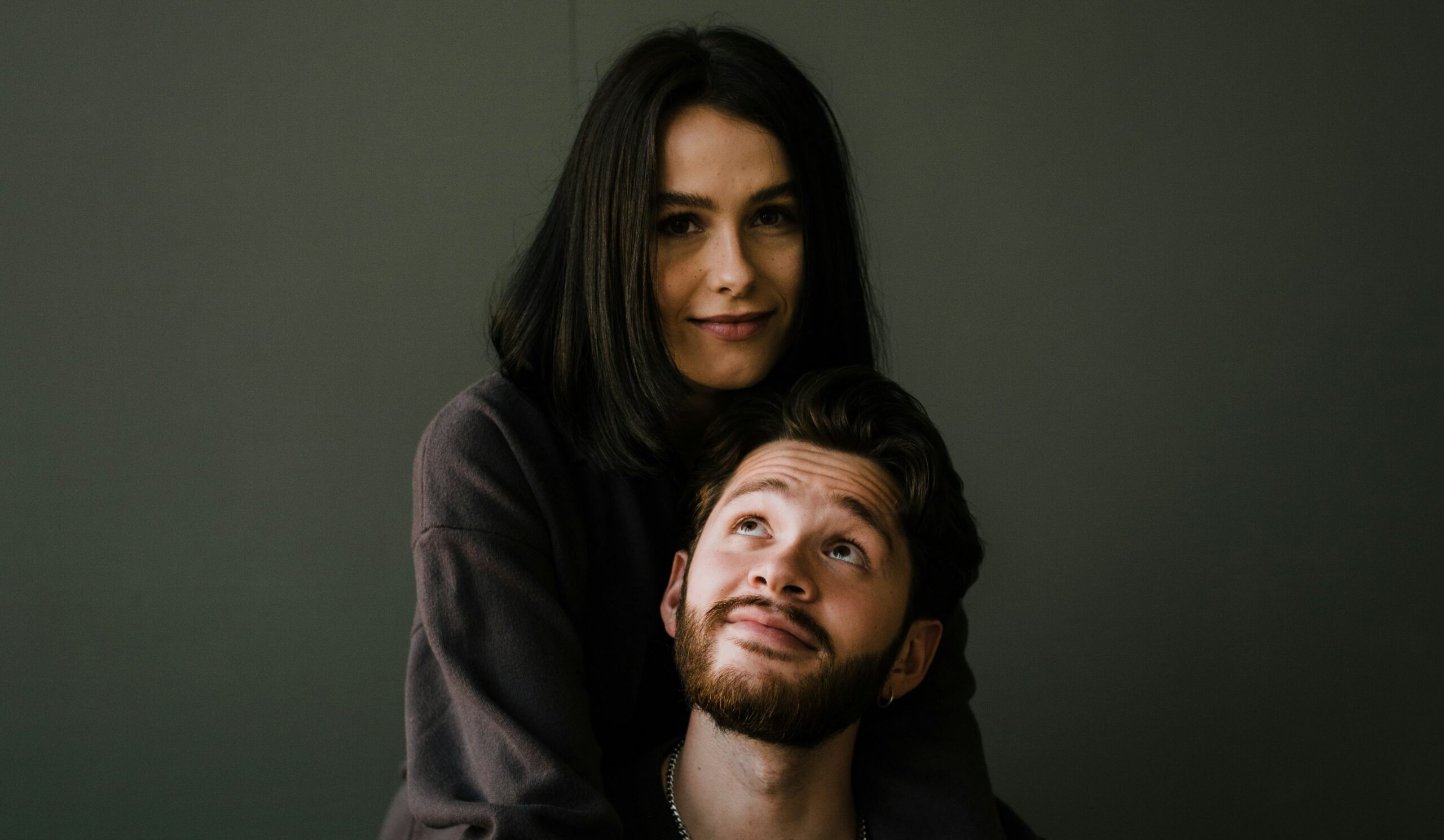 man in black crew neck shirt beside woman in black long sleeve shirt