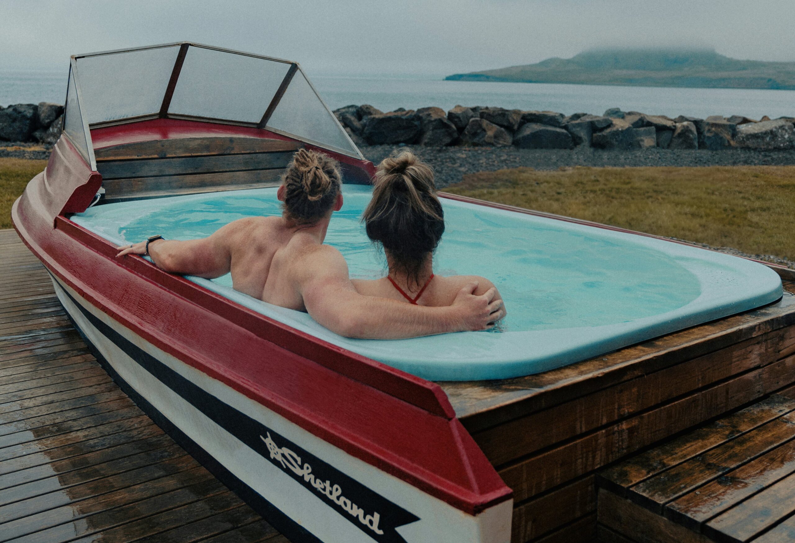 swinger couple in a boat on a dock