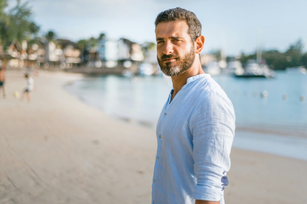 man standing-on-beach-during-daytime