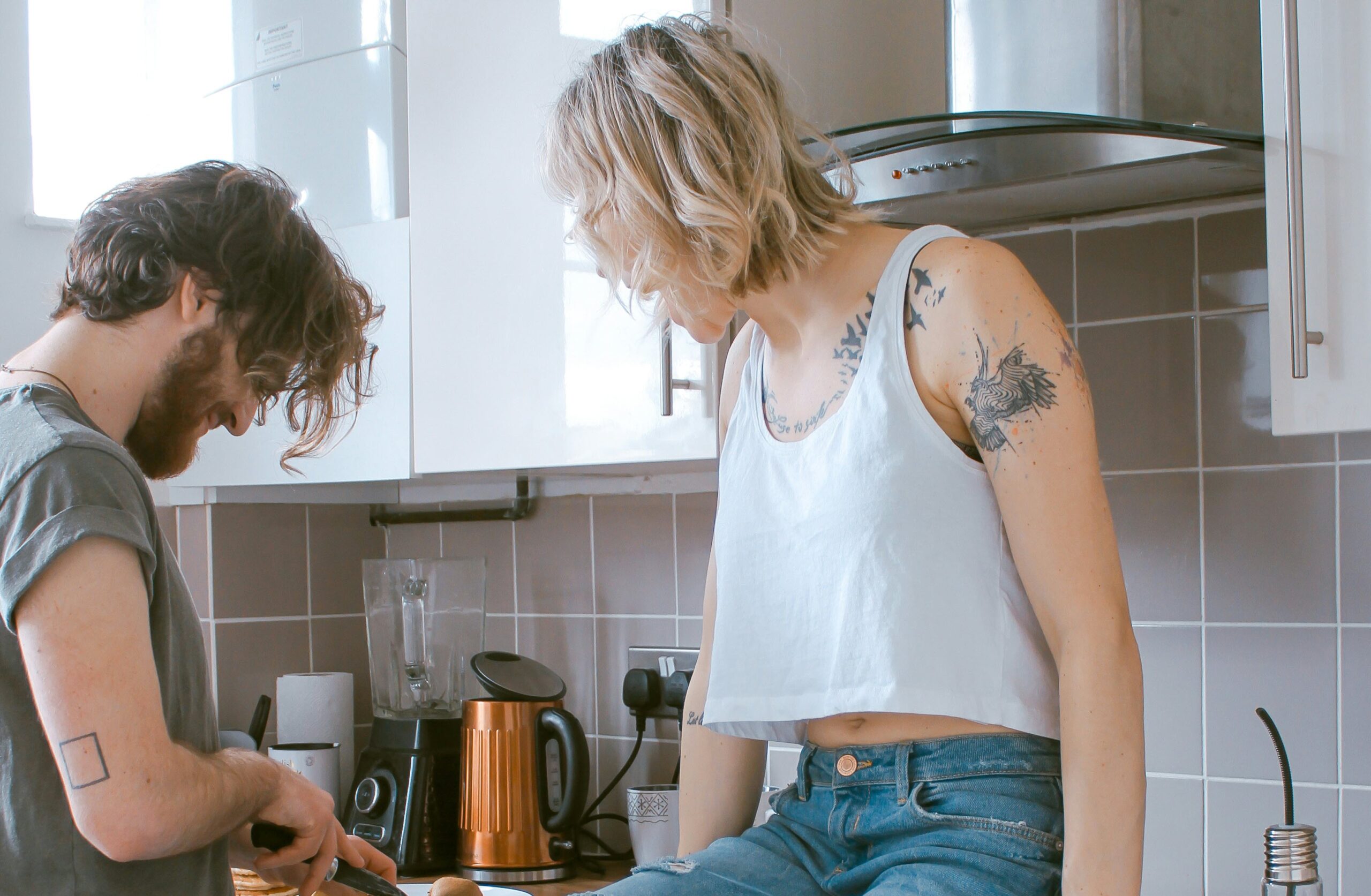 woman and man in kitchen talking