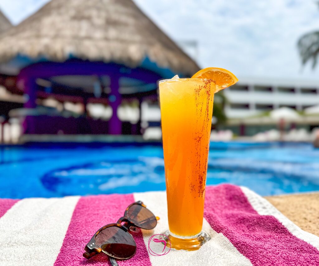 Picture of drink on beach towel near pool