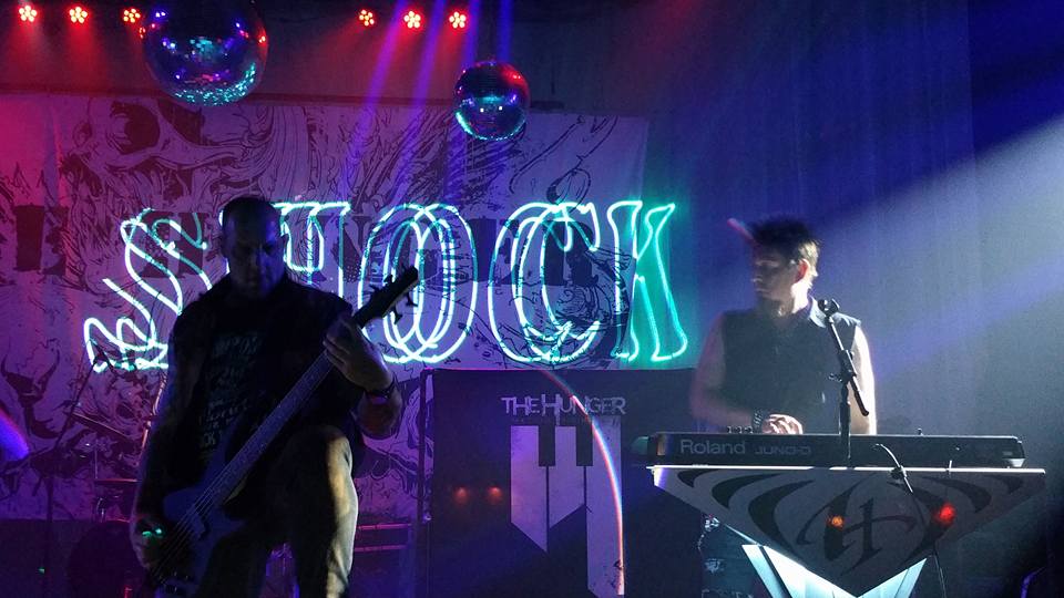 Image of a man holding a guitar in the club