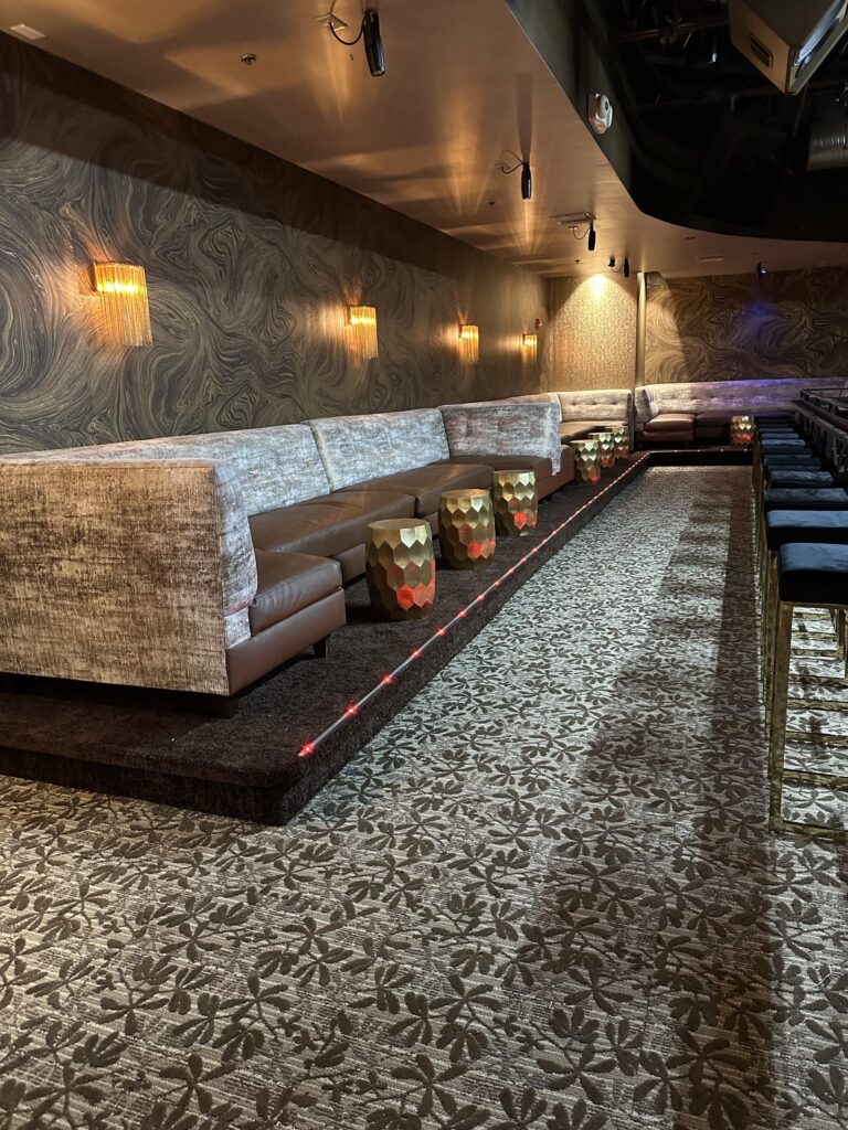 couch with brown leather and carpet floor