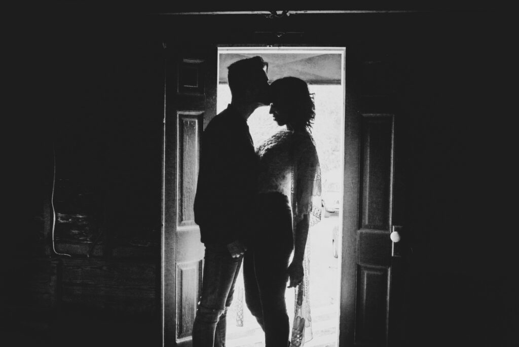 man kissing womans forehead