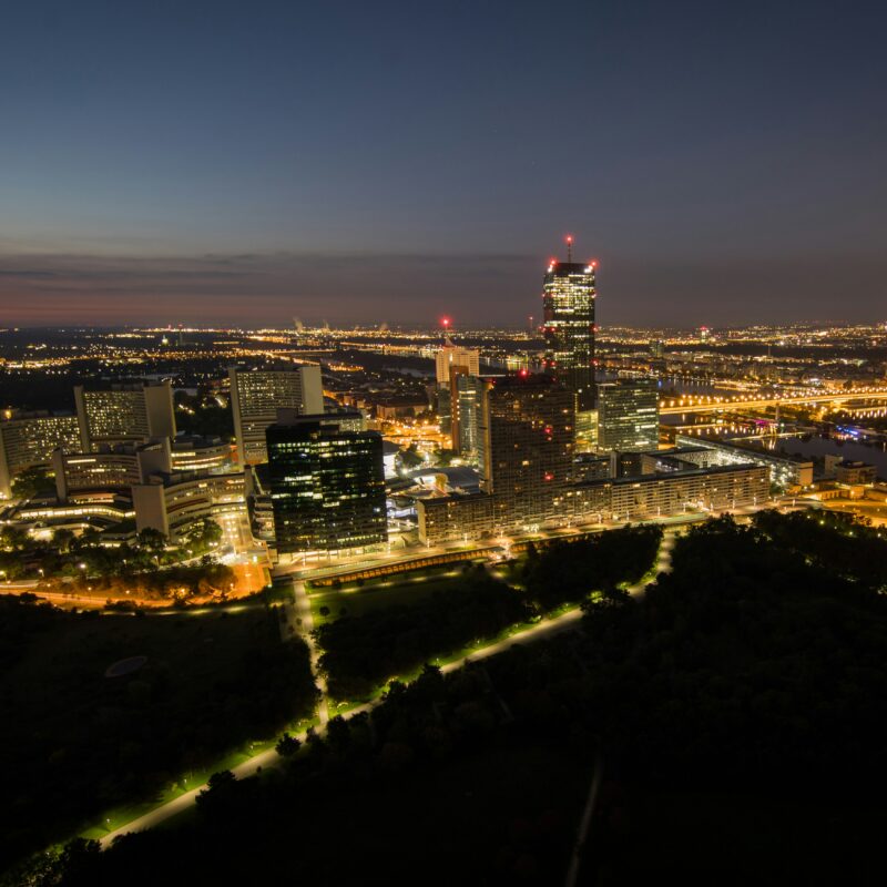 a view of a city at night from the top of a hill