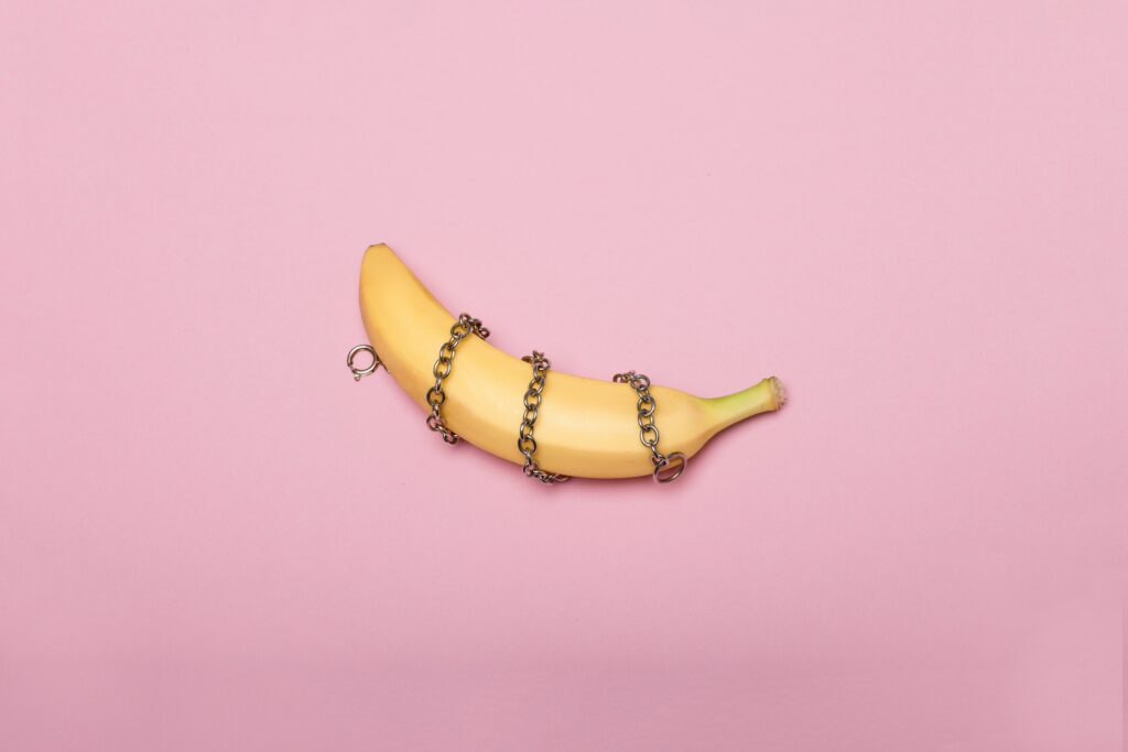 yellow banana on pink surface