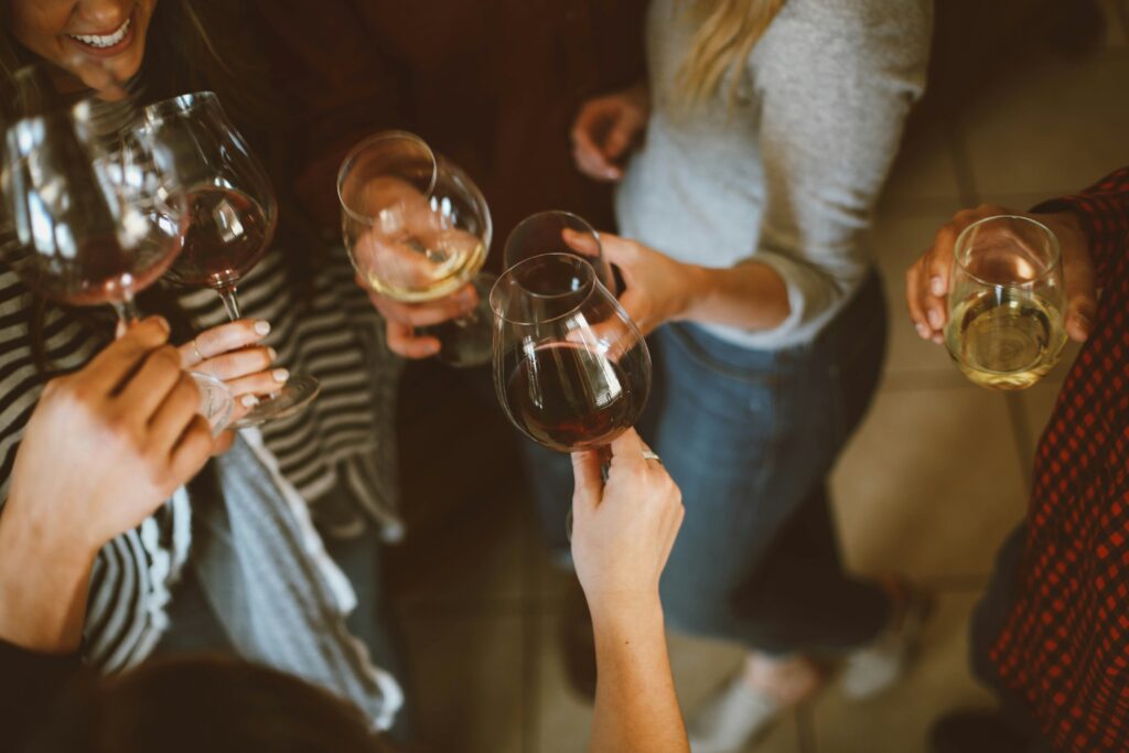 Images of people holding wine glasses