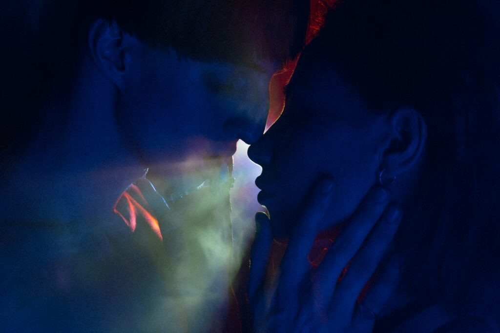 a couple of people that are kissing in the dark