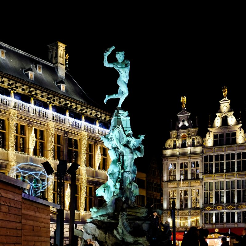 white concrete building with statue during night time