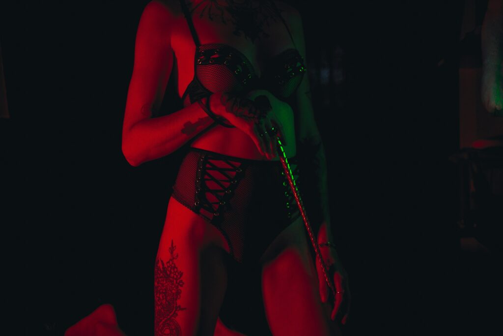 woman in black lingerie in red and green light
