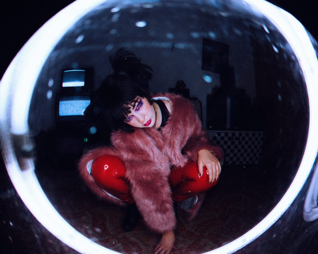 a woman in a fur coat and red gloves