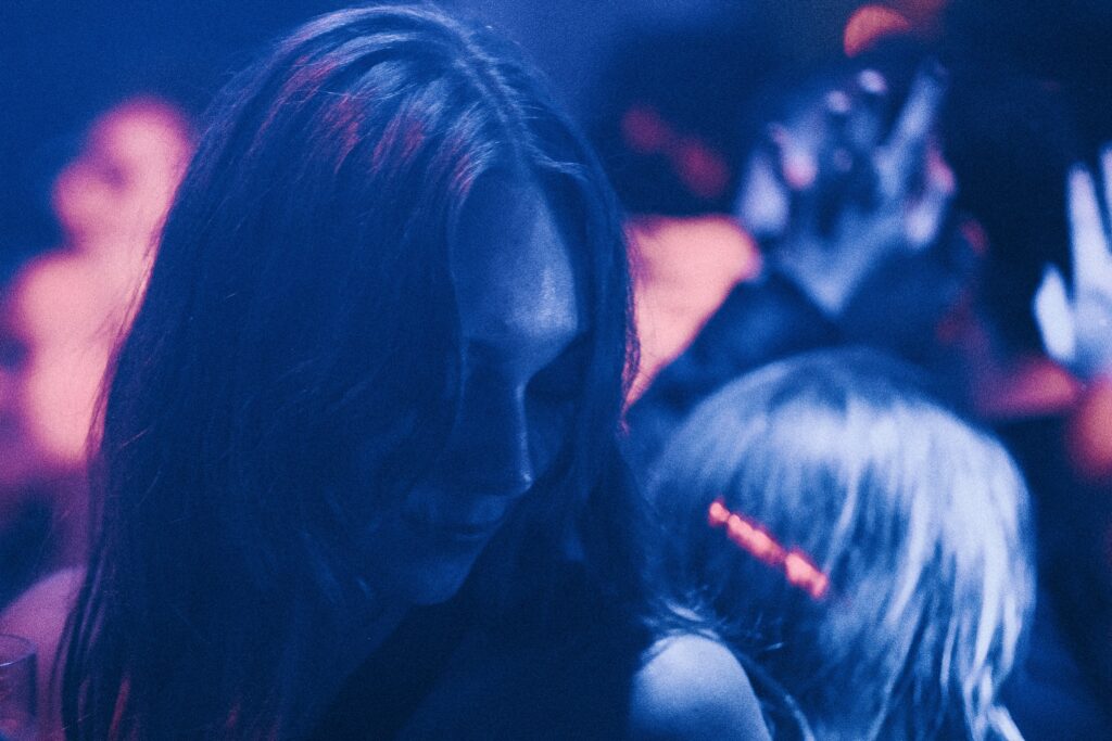 a woman standing in front of a crowd of people