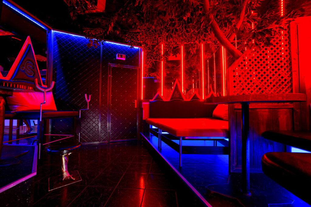 red lights black door wooden table