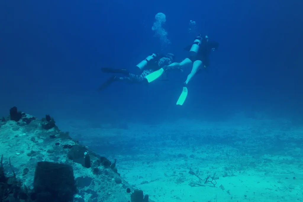 Swinger couple enjoying scuba diving adventure near Hedonism II 