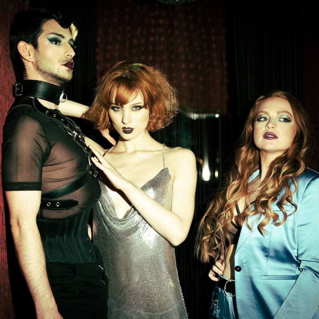 Image of two woman and a man standing