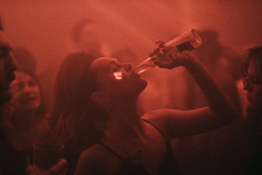 a group of people standing in front of a red light