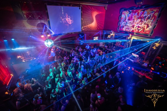 Blue lights at the club with people standing