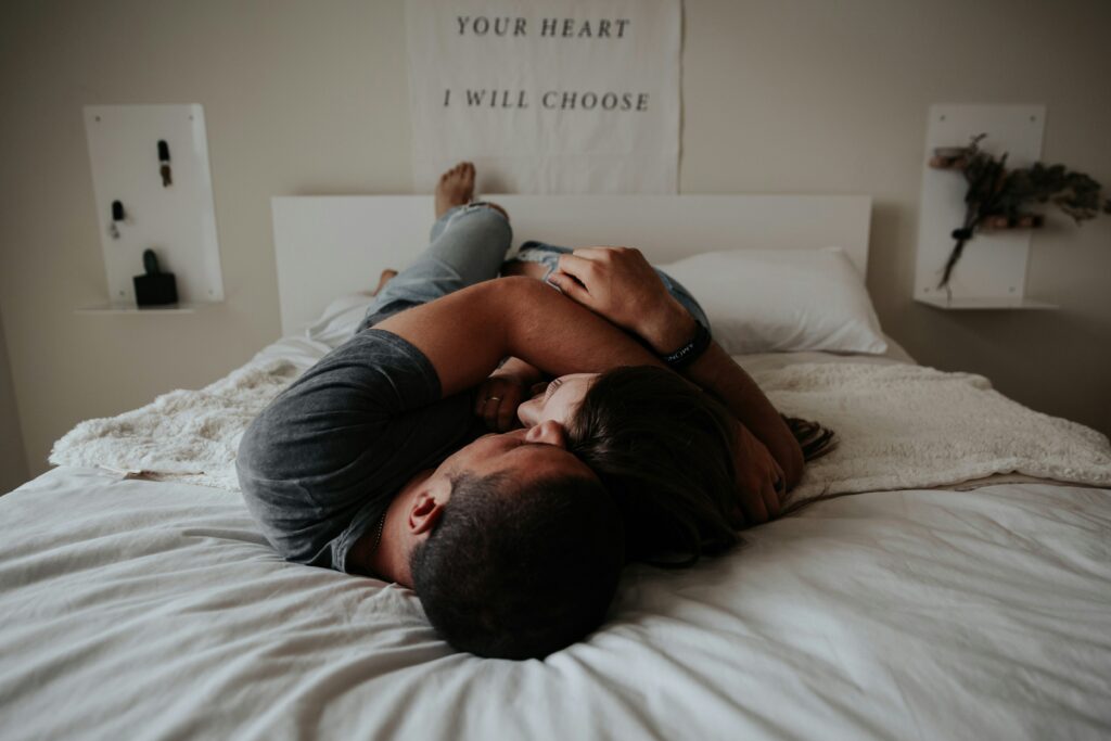 man and woman hugging in the bed
