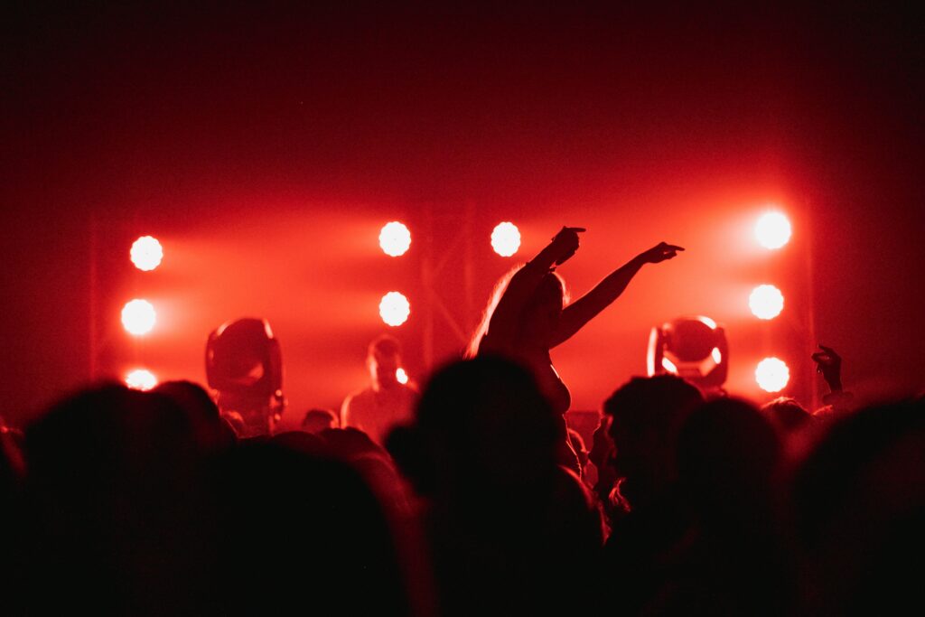 People raising their hands during night time