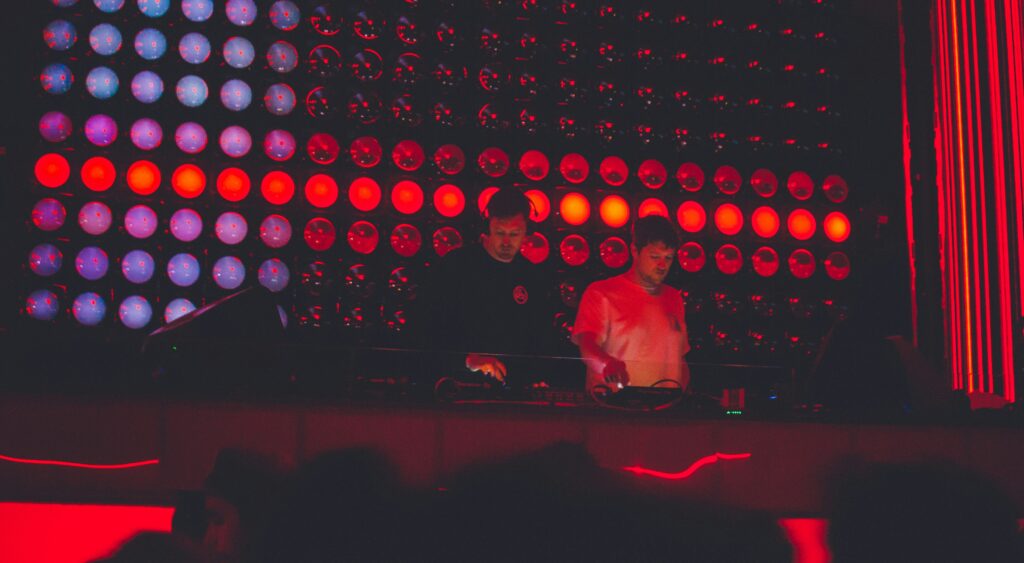 two djs performing on stage