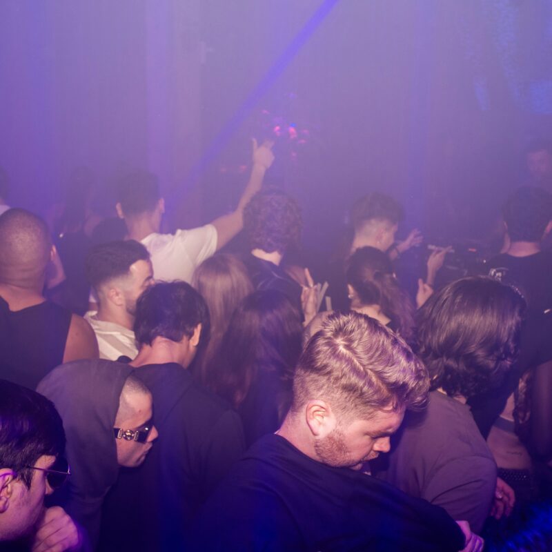 a crowd of people standing around a nightclub