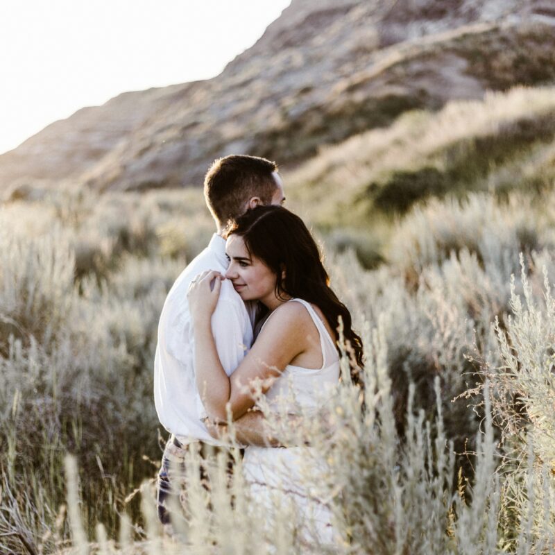 hugging woman near mountain