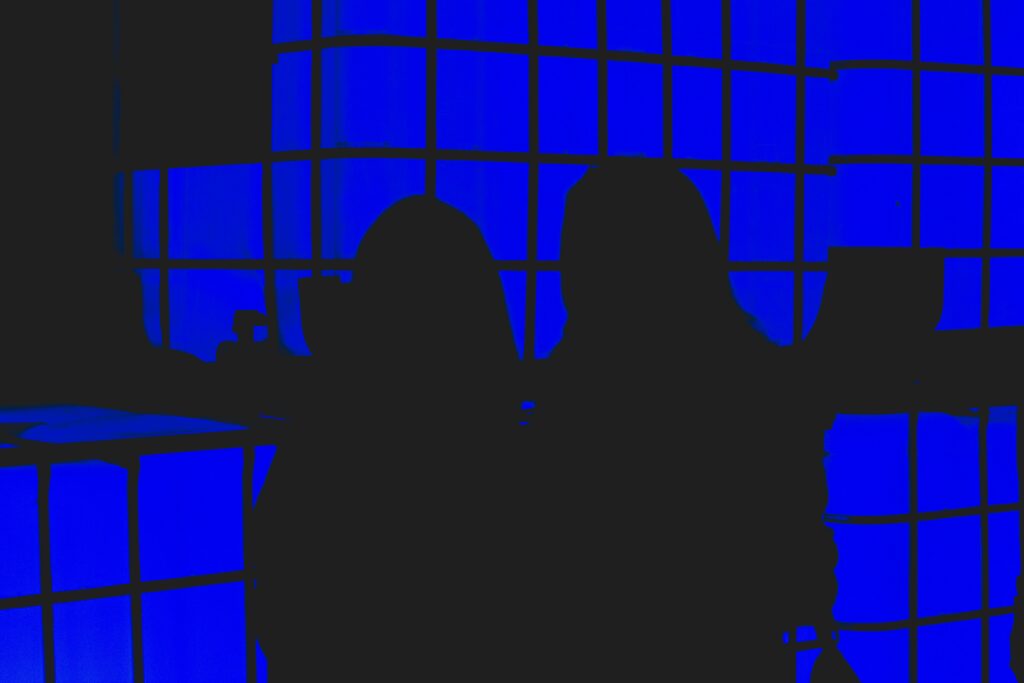 Woman silhouette in the dark blue