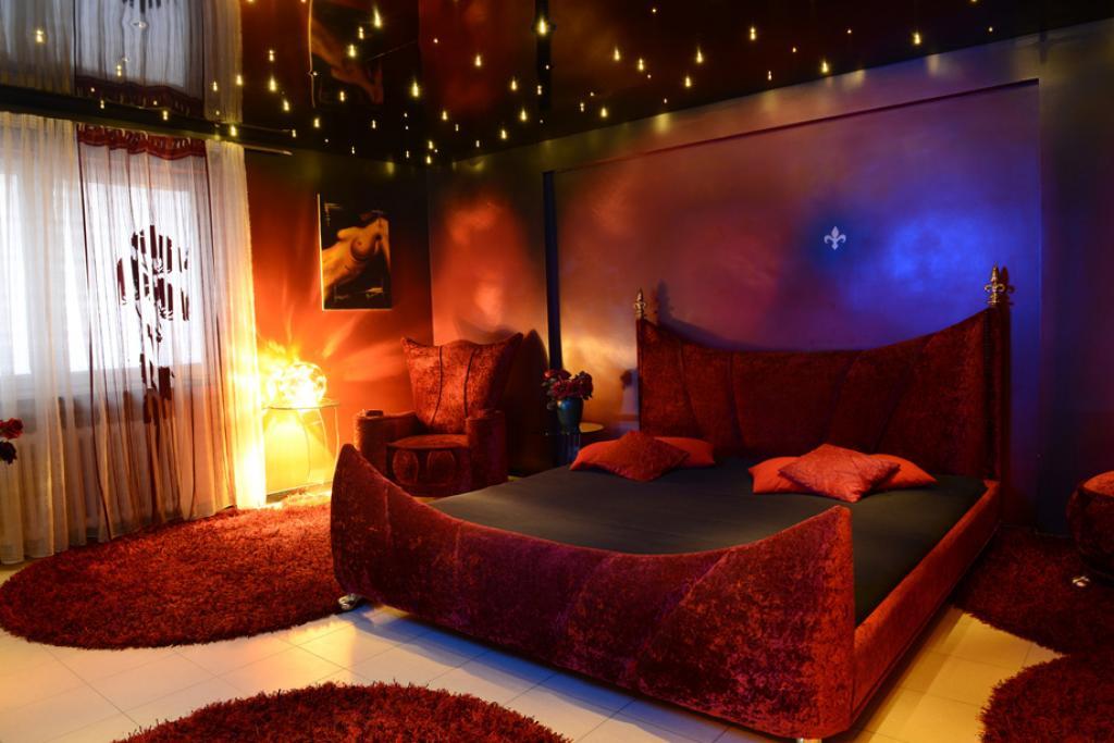 Red bedroom with lights in the ceiling
