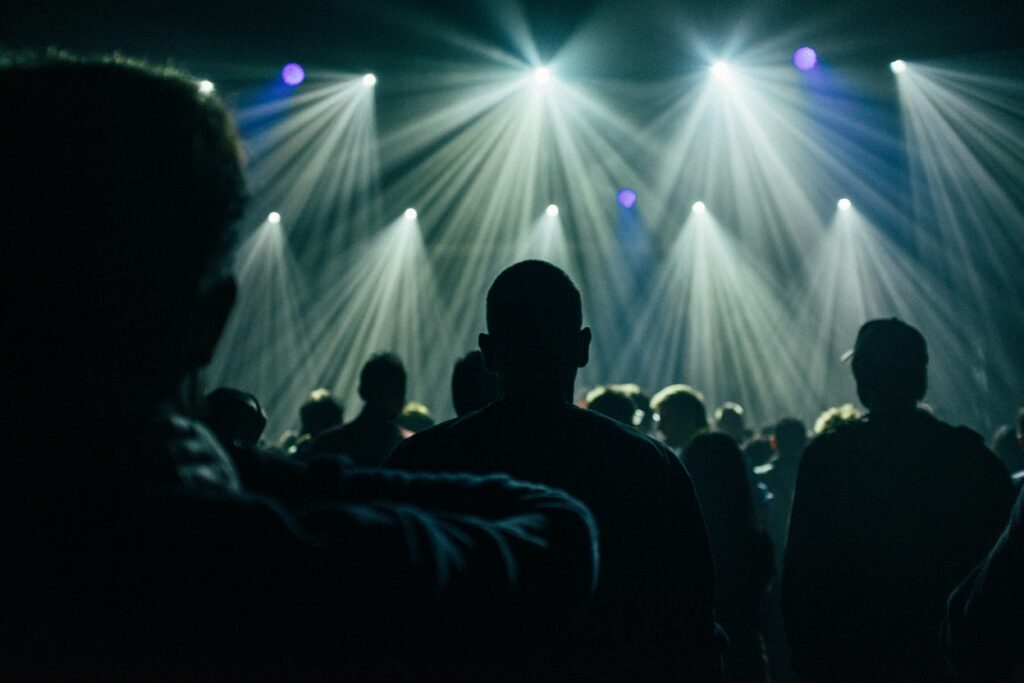 a group of people standing in front of a stage