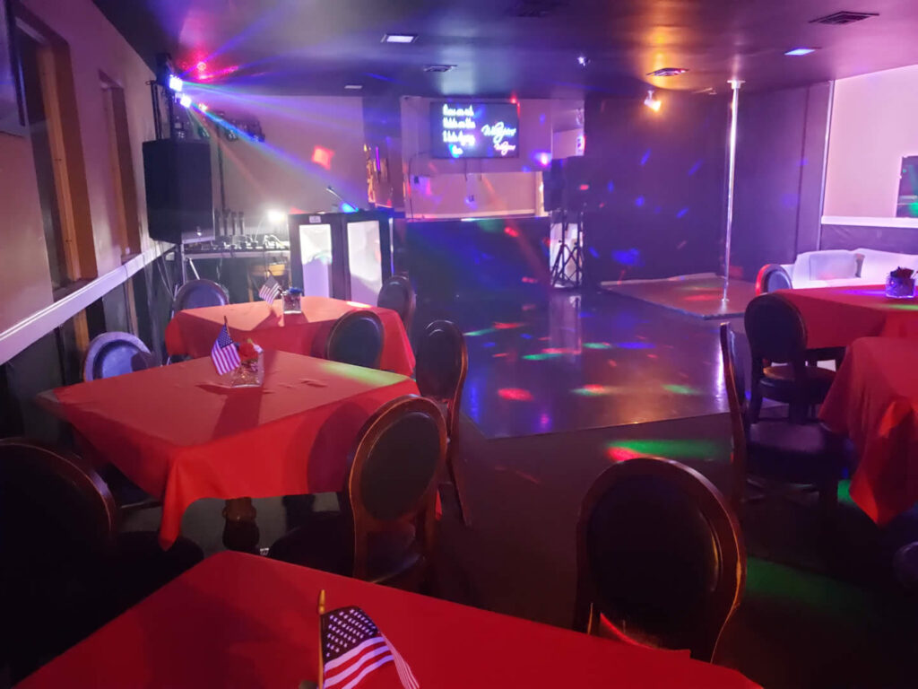Chairs and tables in the club with lights open
