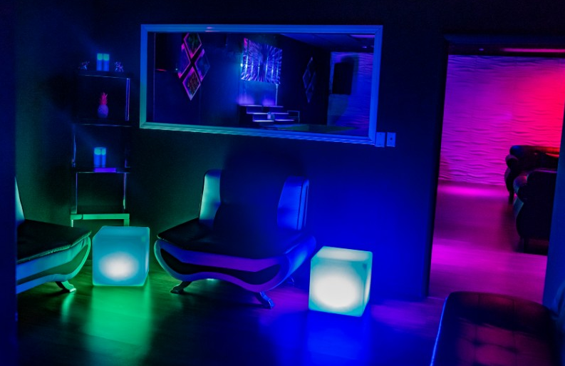 A big couch and lights in the floor