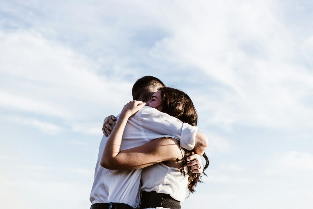 man and woman hugging each other photograph