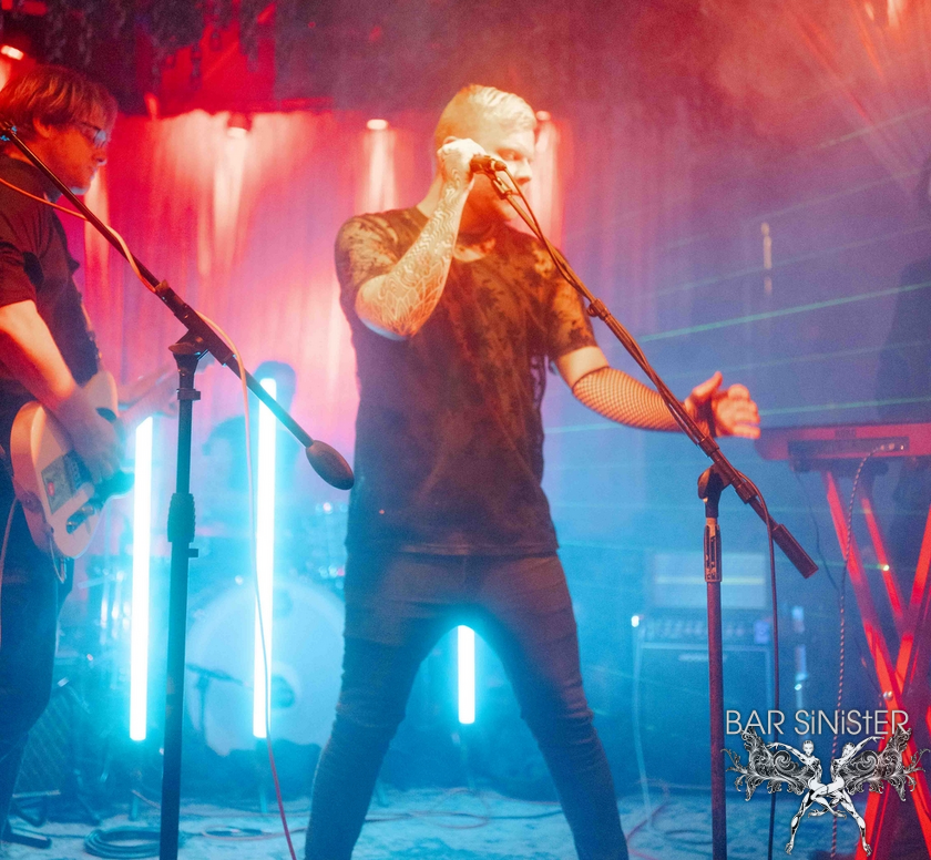 Man in the stage holding a microphone