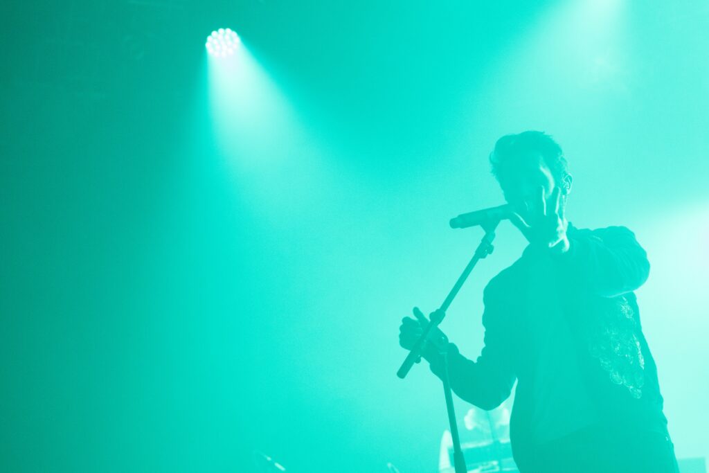 Man holding a microphone while singing